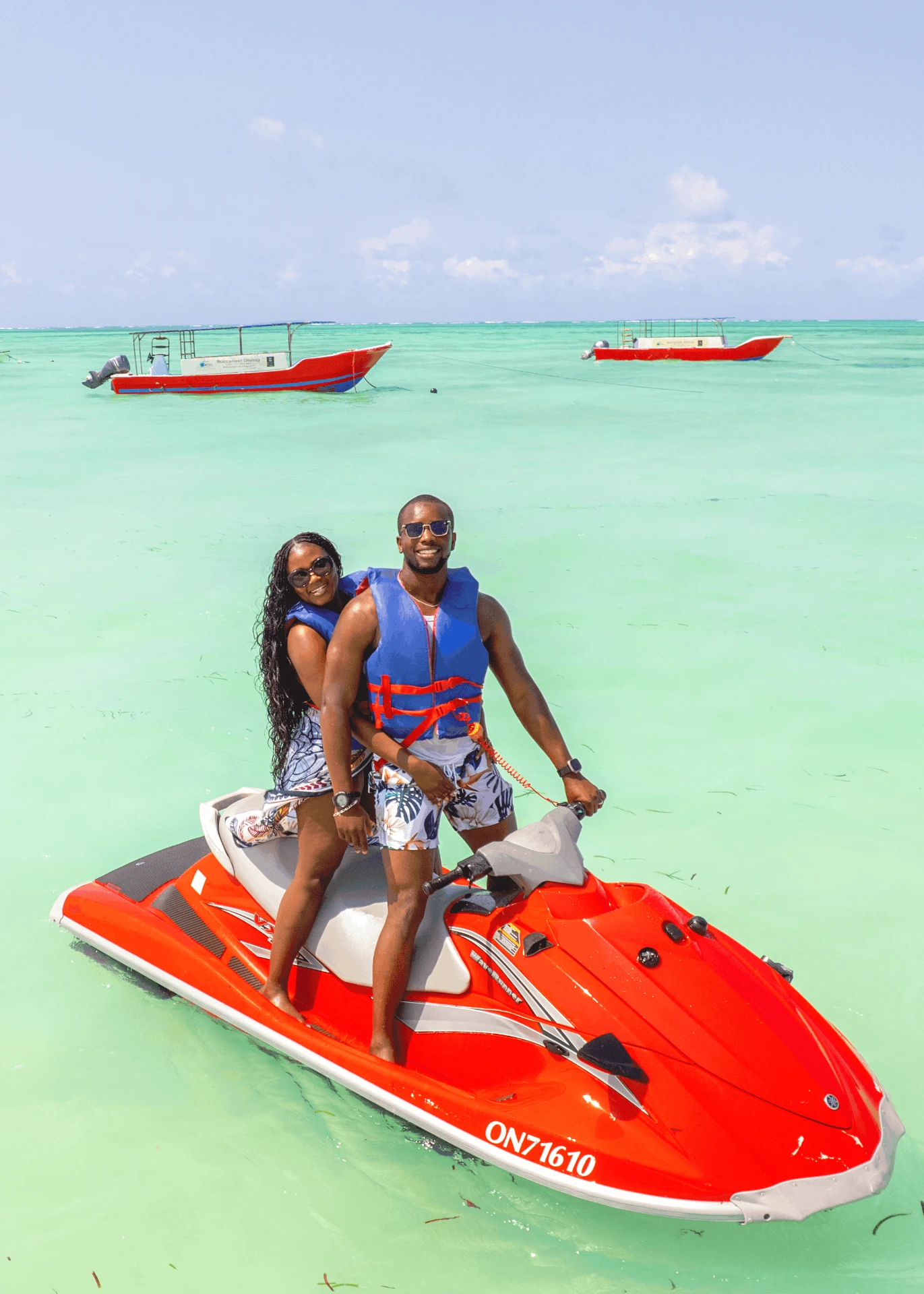Jet ski in Paje, Zanzibar — couple standing on a red Yamaha WaveRunner in the turquoise lagoon
