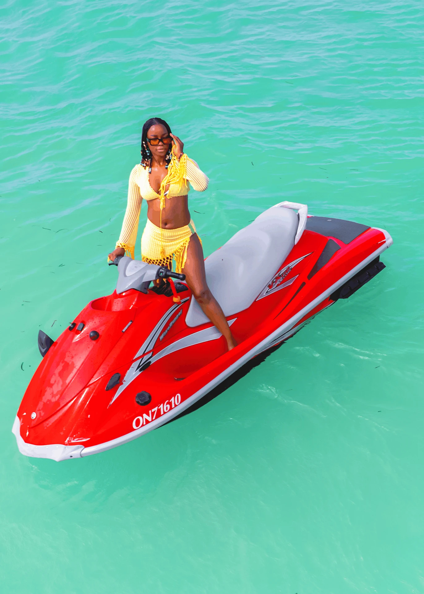 Jet ski in Paje, Zanzibar — guest posing on a red Yamaha WaveRunner in the shallow lagoon