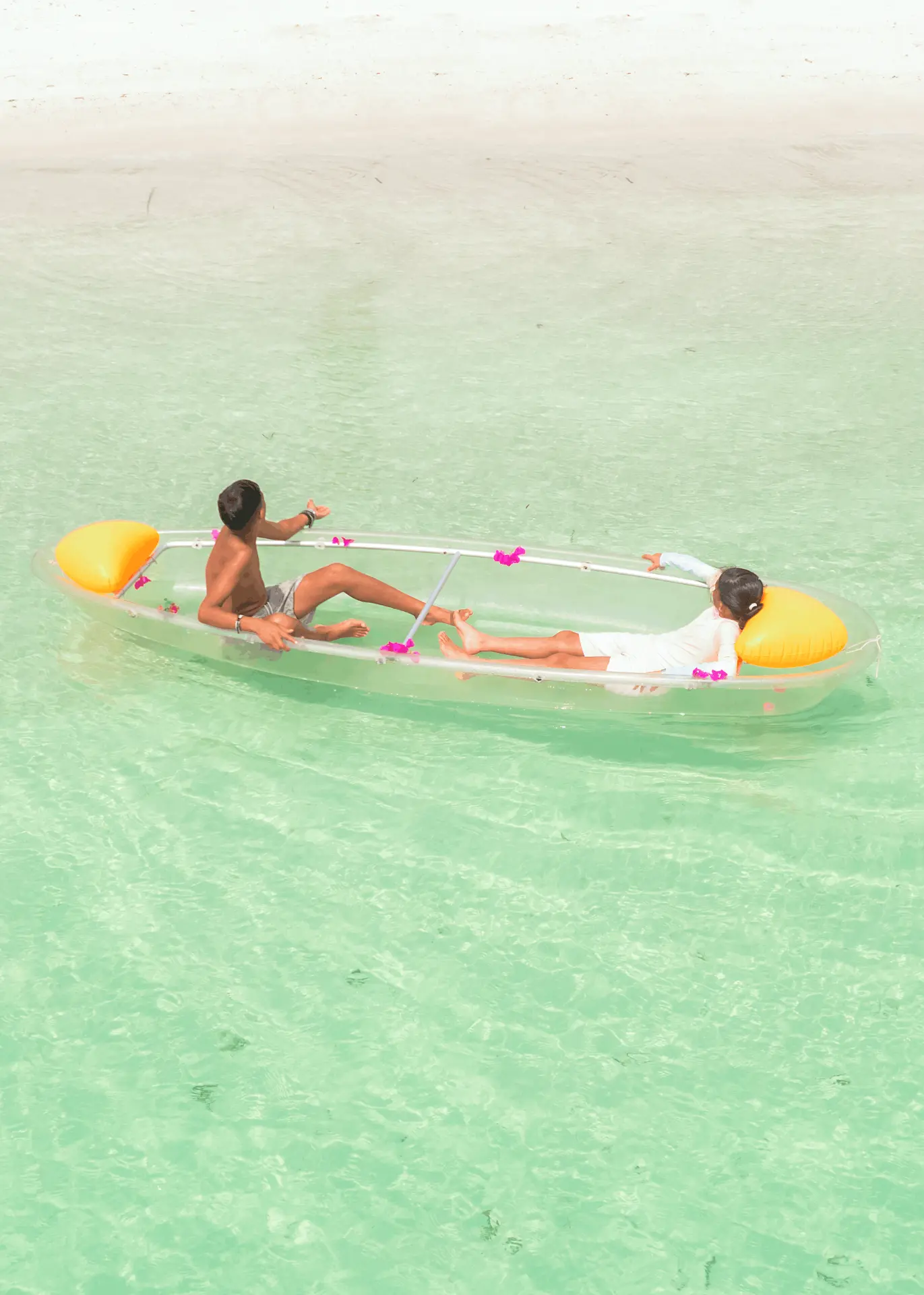 Transparent kayak in Paje, Zanzibar — couple relaxing in a clear kayak near the beach